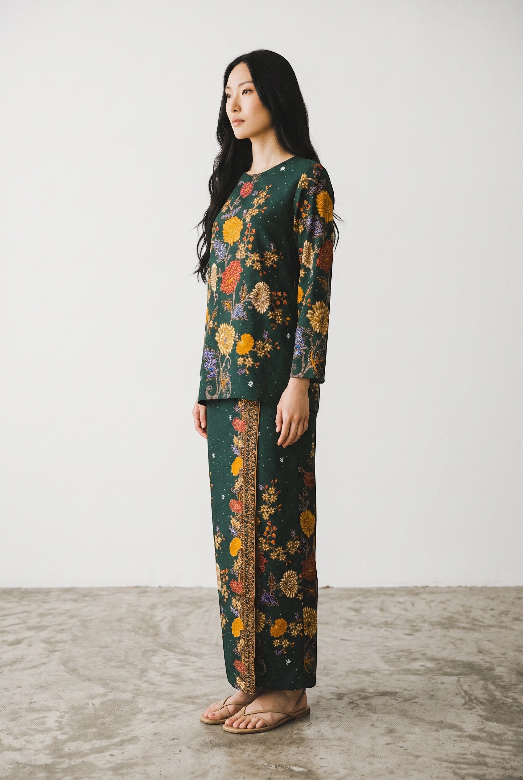Model wearing a PARCA green floral print cotton long-sleeve top and matching maxi sarung skirt