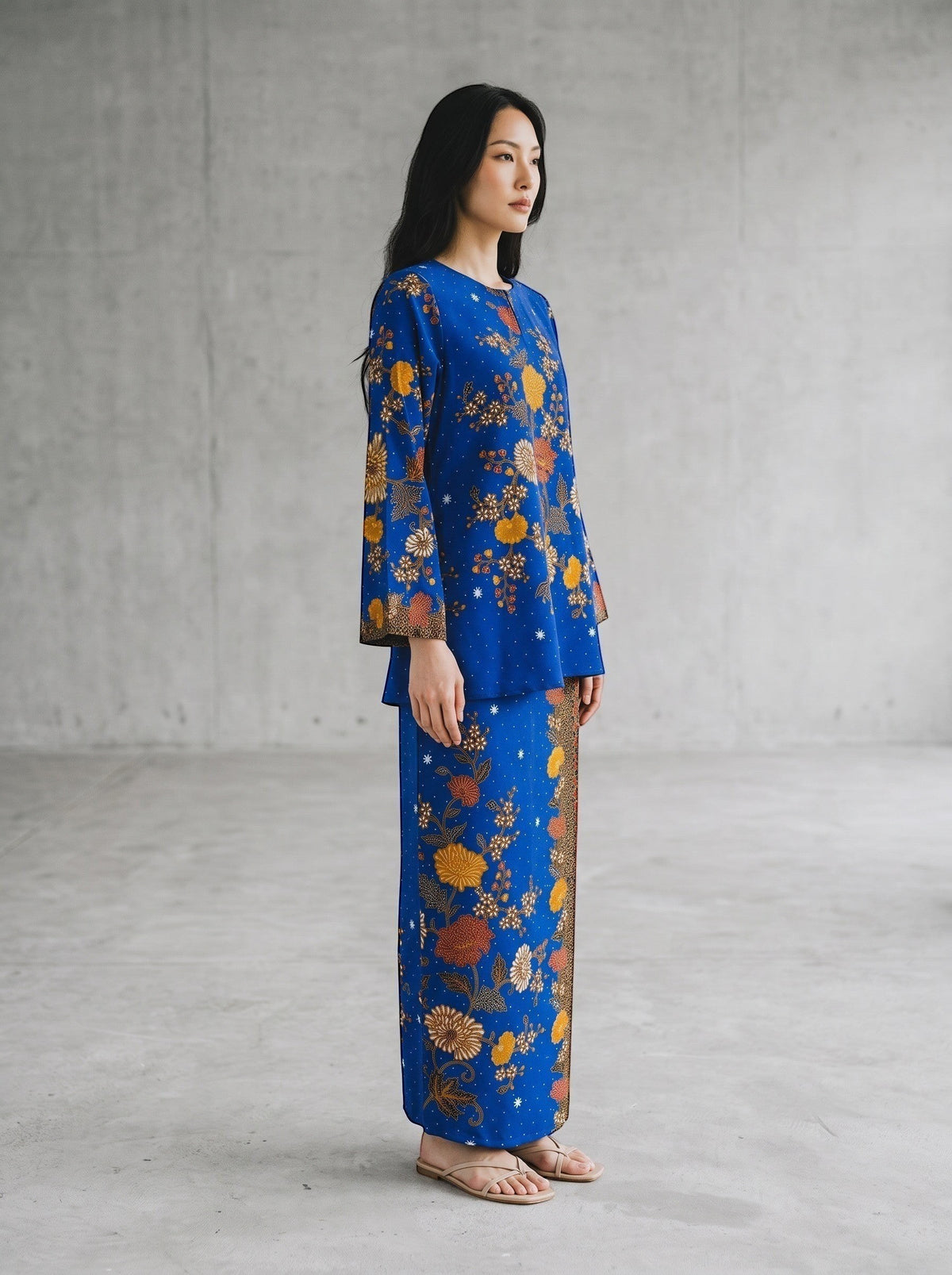 PARCA Nayra royal blue cotton top and sarung set with floral batik print and flared sleeves worn by a model