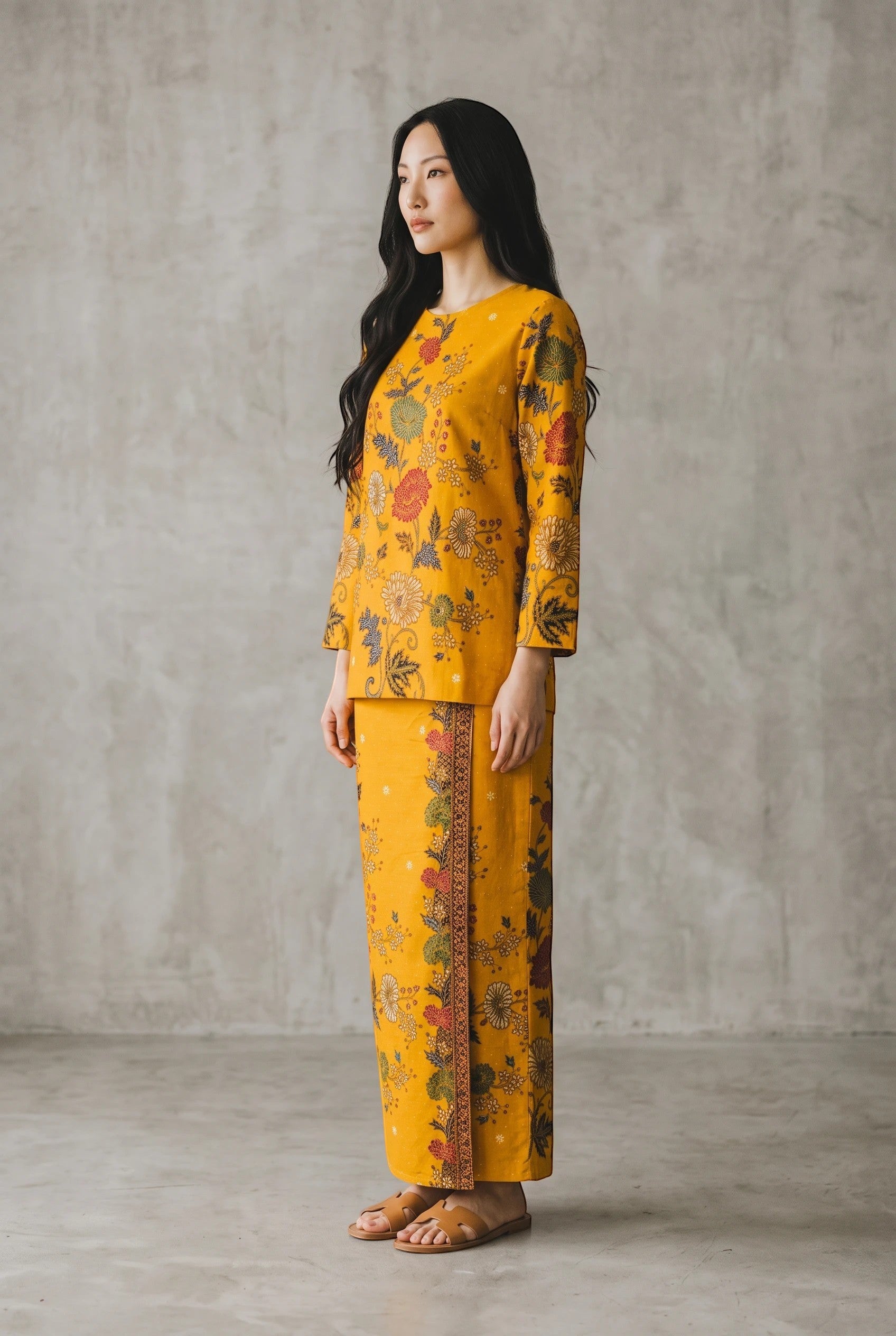 PARCA Nayra yellow long-sleeve top and matching sarong skirt with intricate floral batik print on a model