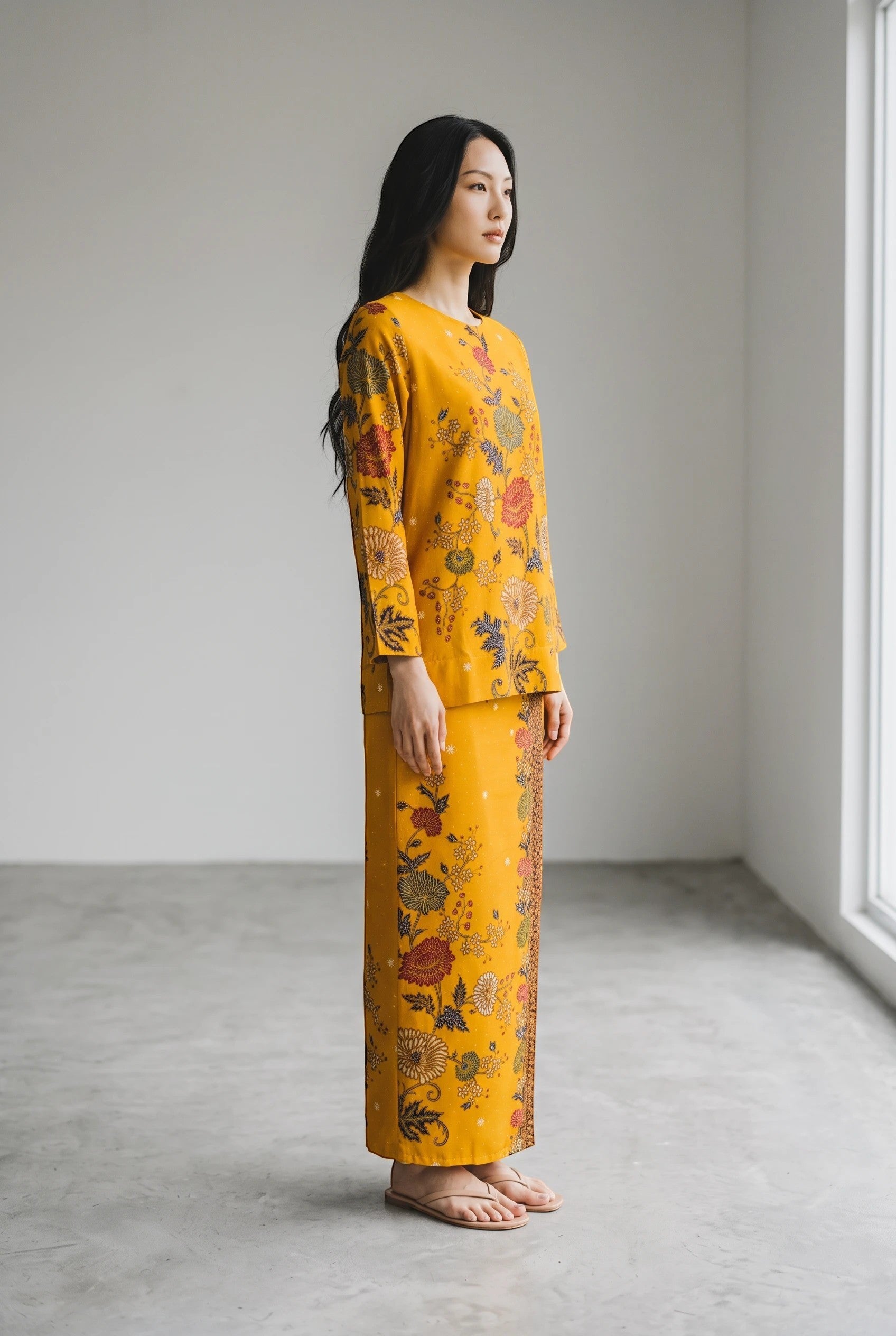PARCA Nayra in Yellow long-sleeve top and matching skirt with intricate floral batik print in warm mustard tones