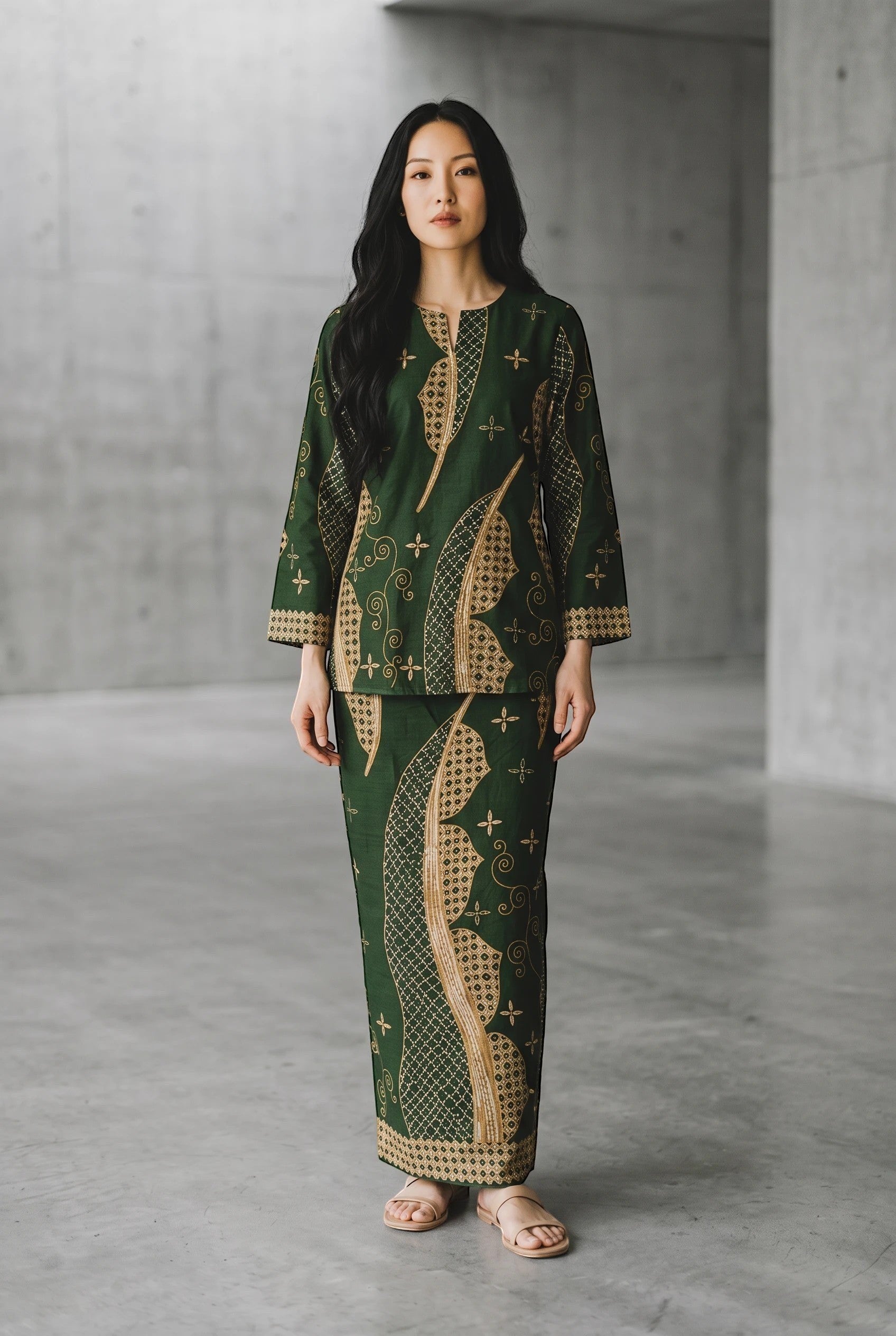 Model wearing a green cotton PARCA top and matching maxi sarung with traditional batik-inspired patterns