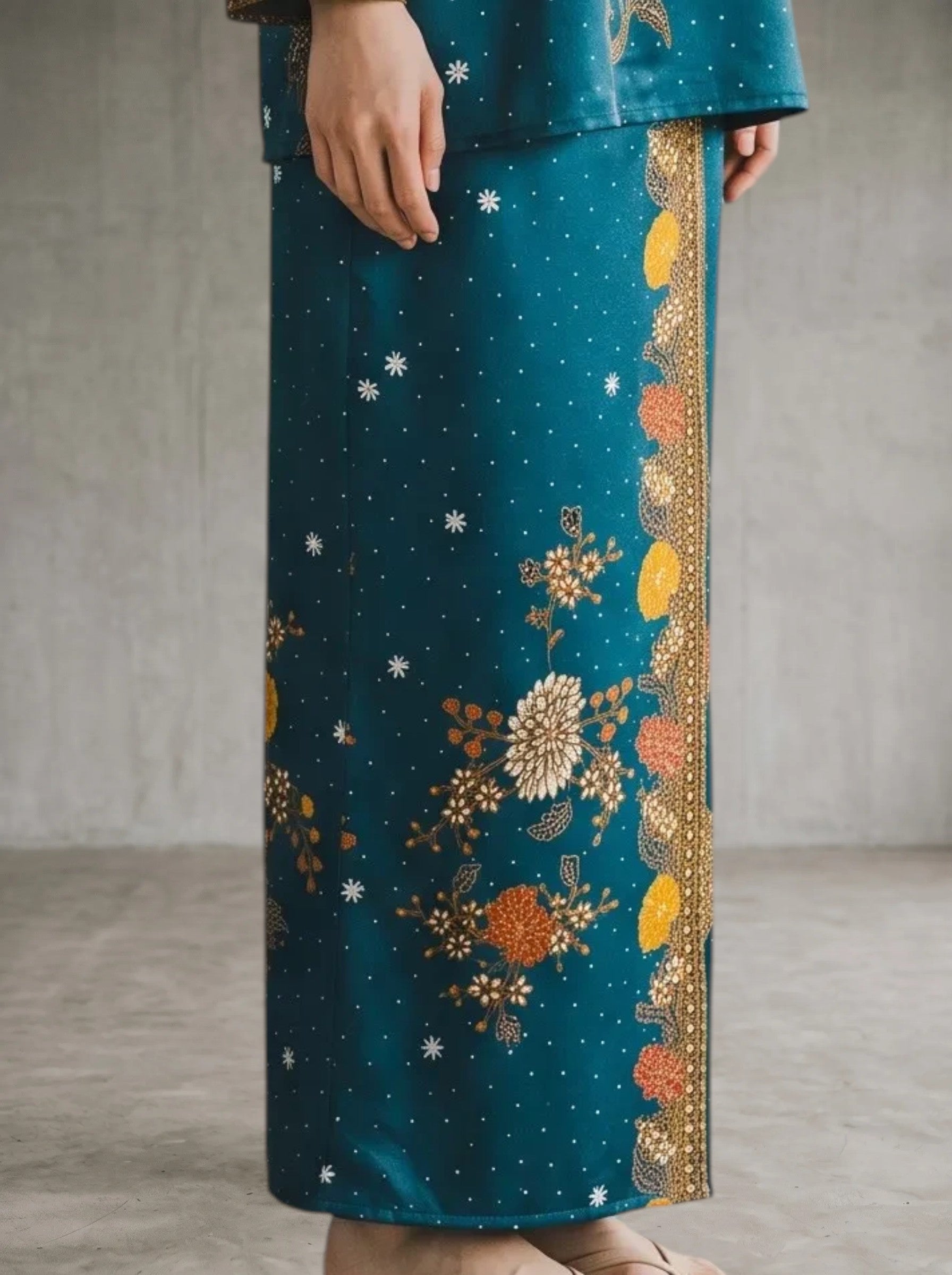A model wearing a turquoise PARCA cotton set with a floral print top and matching maxi sarong skirt.
